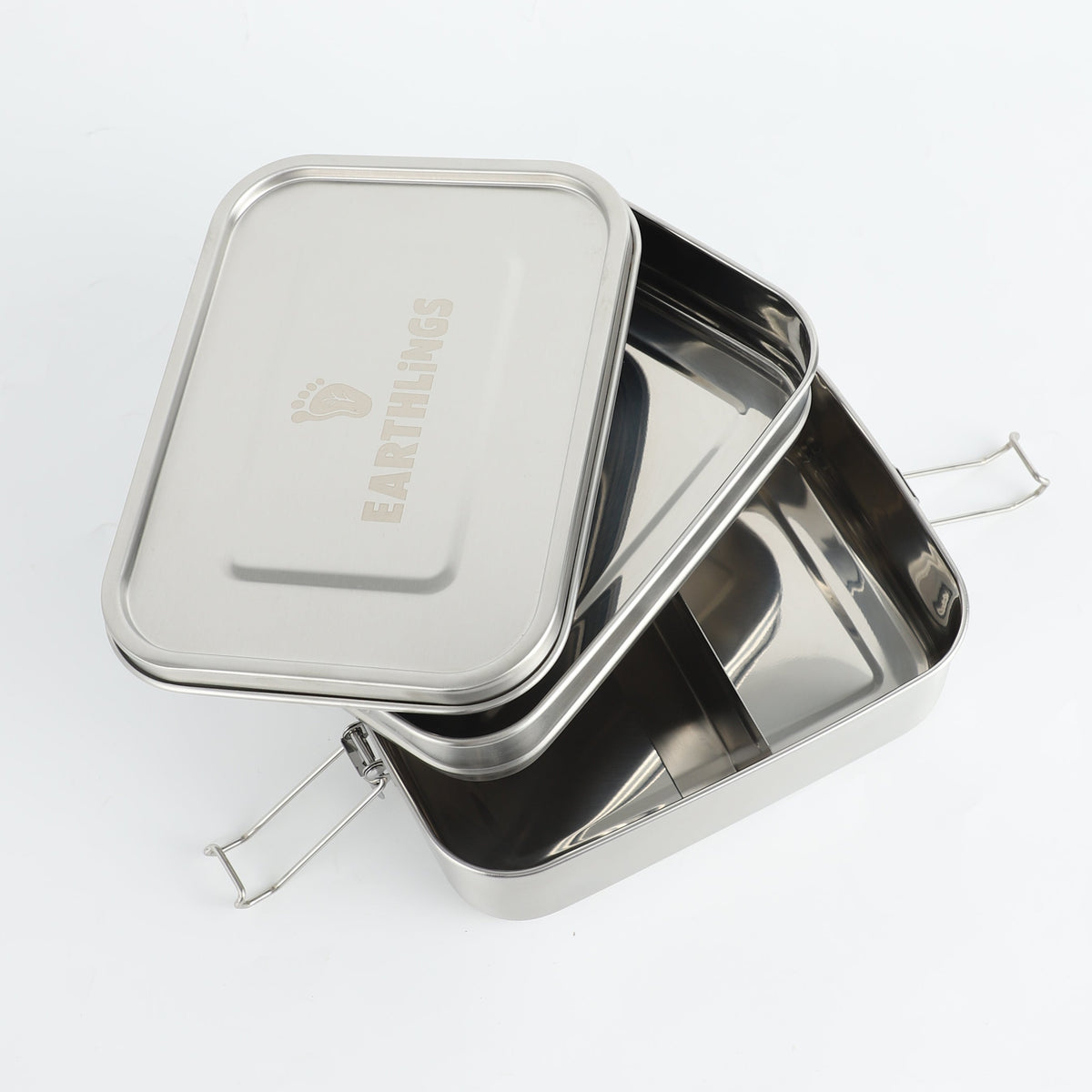 A 2 tier bento stainless steel lunchbox. Open showing a top and bottom tier. Earthlings logo laser etched onto the lid. 